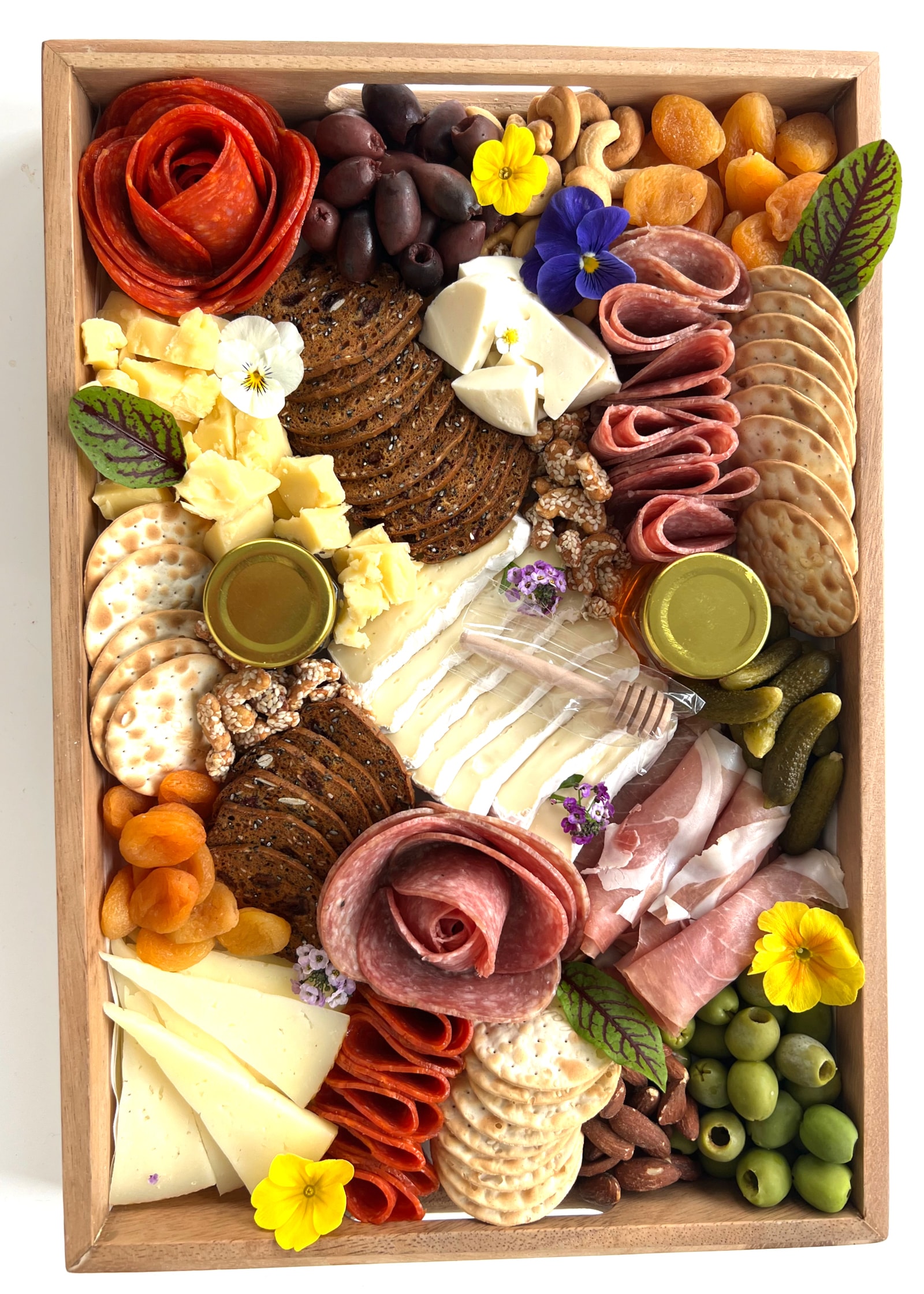 A grazing board with meats, cheeses and fruit