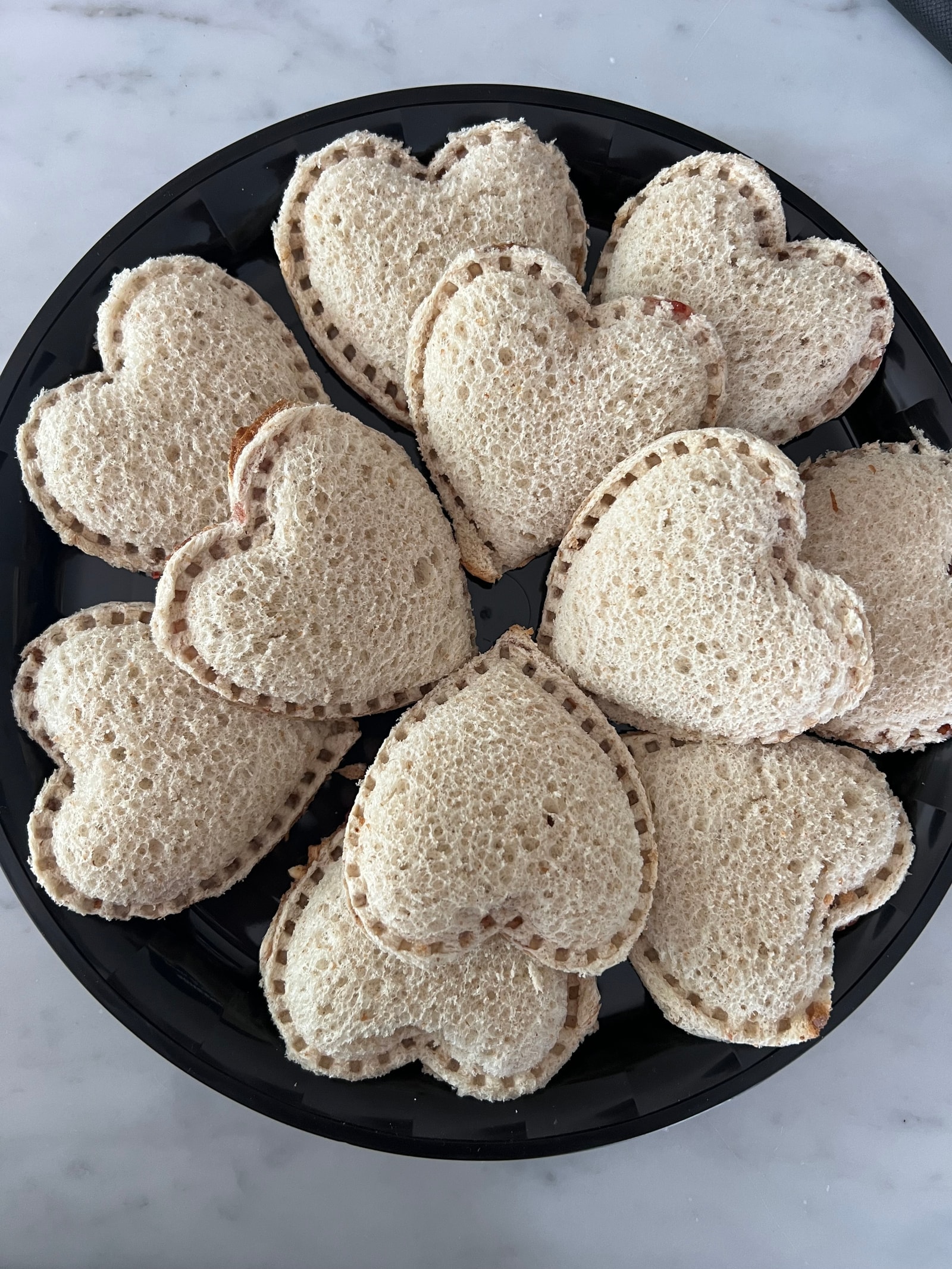 A platter of heart-shaped sandwiches