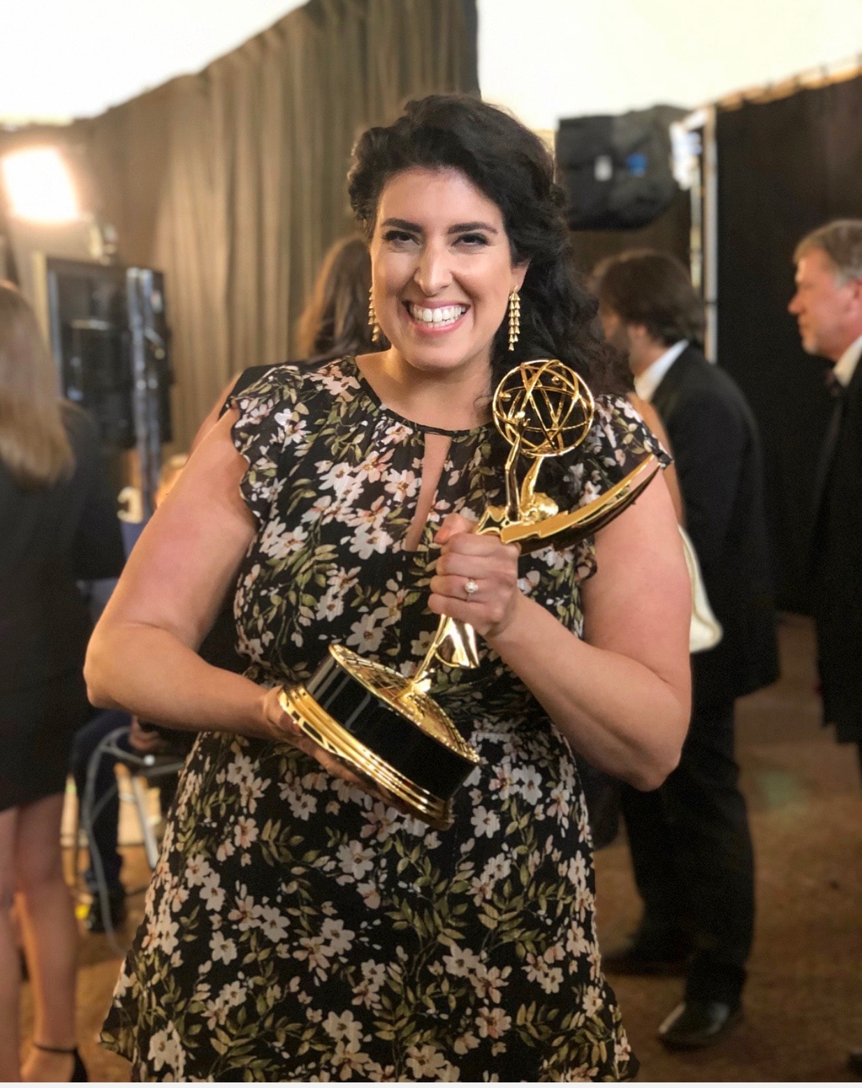 Jeanette Donnarumma backstage holding her Emmy, laughing