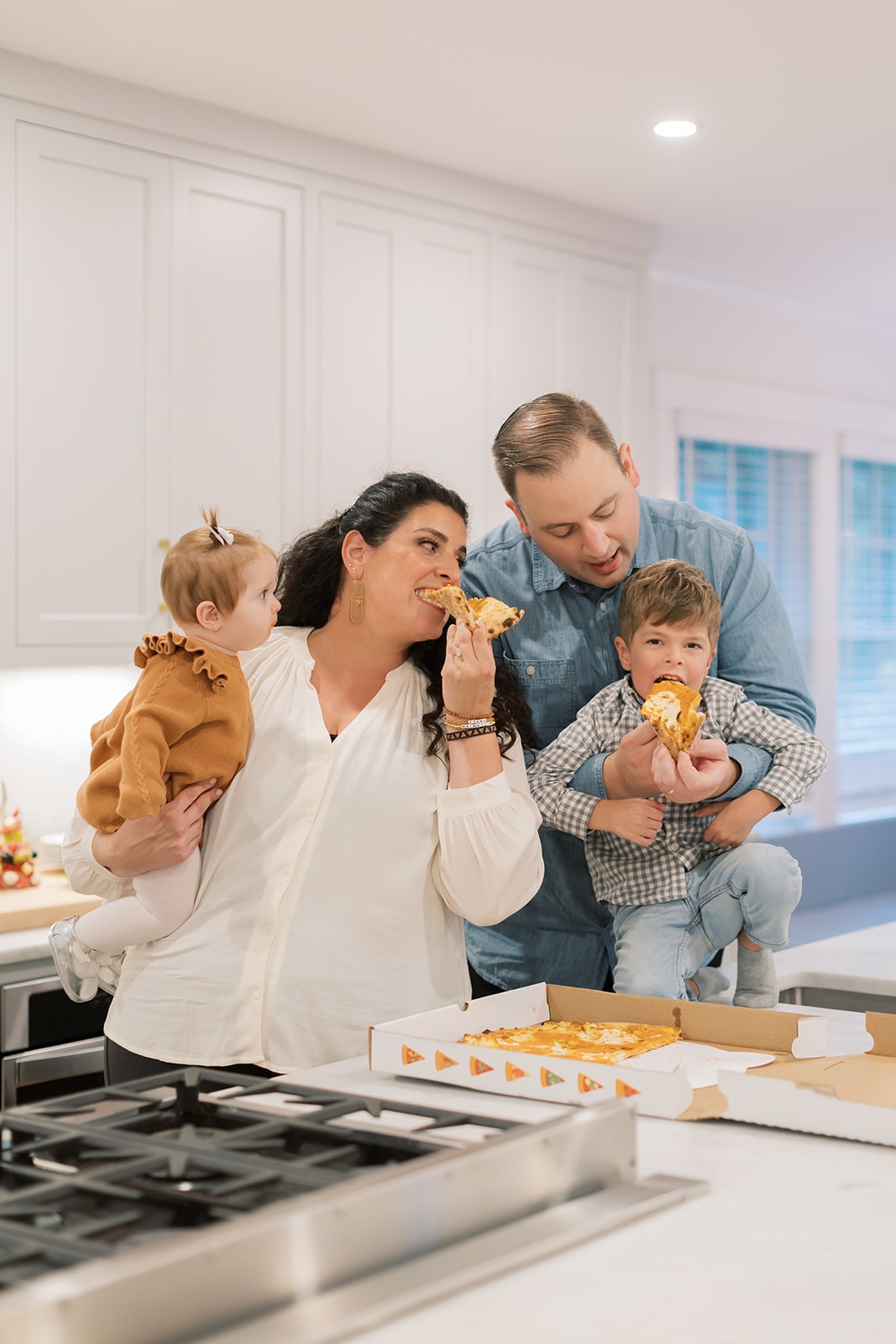 Jeanette and her family eating pizza at the kitchen counter