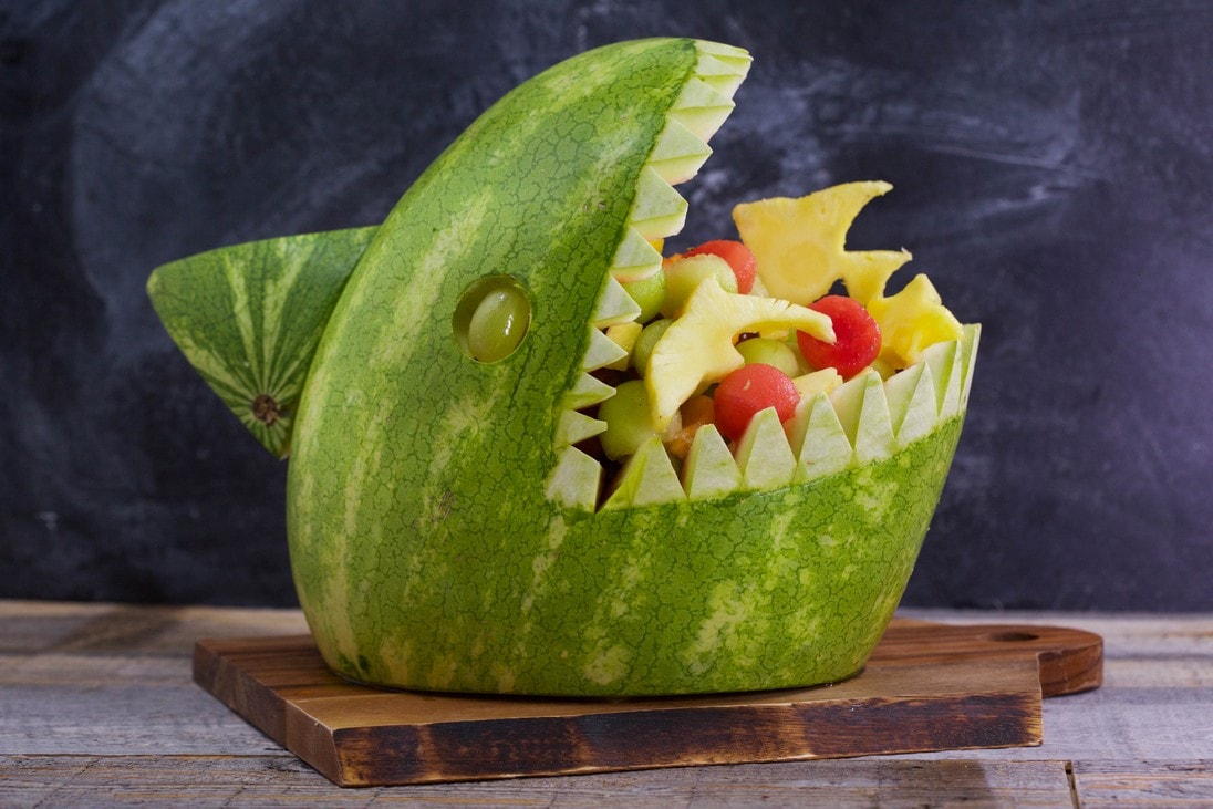 A watermelon carved into a shark, full of fruit